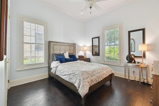 bedroom featuring dark hardwood / wood-style flooring, crown molding, and ceiling fan