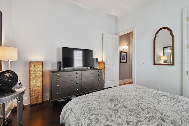 bedroom with crown molding and dark hardwood / wood-style flooring