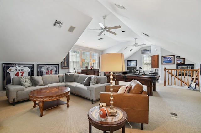 carpeted living room with plenty of natural light and vaulted ceiling