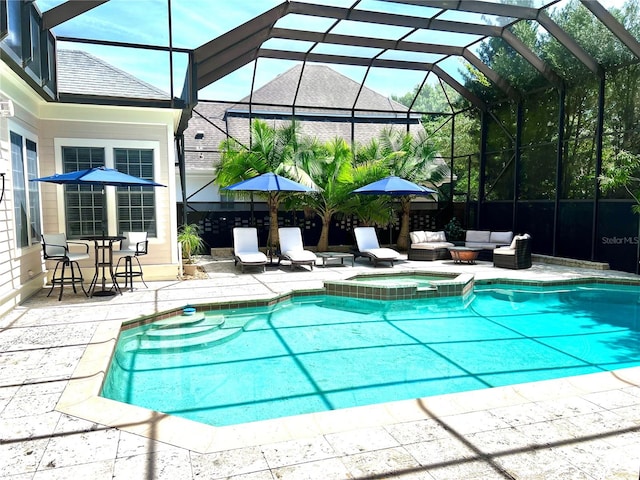 view of pool with an in ground hot tub, an outdoor hangout area, a patio area, and glass enclosure