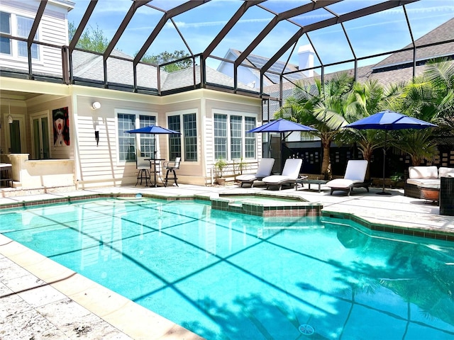 view of pool featuring an outdoor living space, a patio area, an in ground hot tub, and glass enclosure