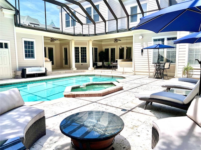 view of pool featuring an in ground hot tub, ceiling fan, and a patio area