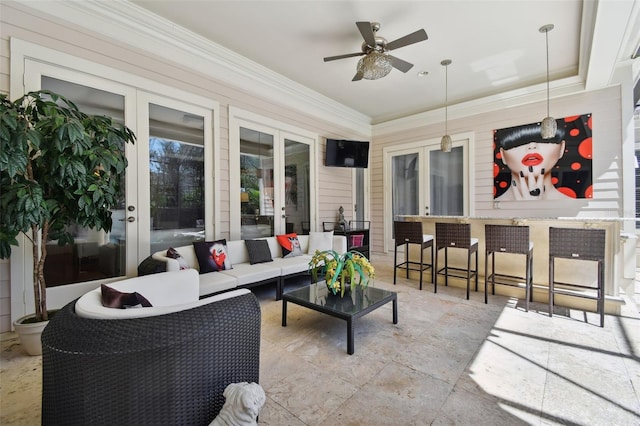 sunroom featuring ceiling fan