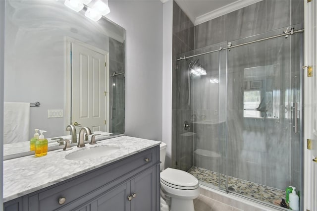 bathroom with ornamental molding, vanity, toilet, and a shower with door