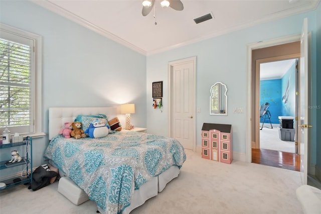 bedroom with ornamental molding, carpet floors, and ceiling fan