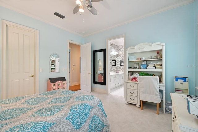 carpeted bedroom featuring crown molding, ceiling fan, and ensuite bath