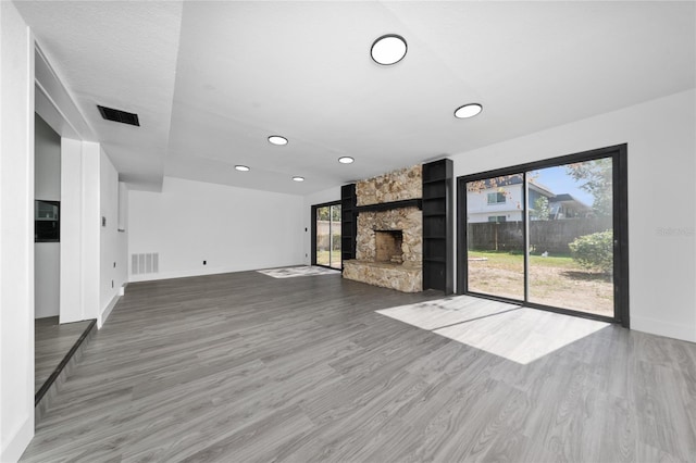 unfurnished living room with wood-type flooring and a fireplace