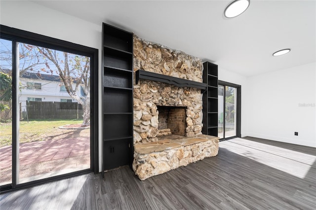 unfurnished living room with a fireplace and dark hardwood / wood-style floors