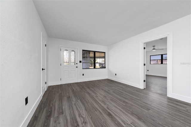 interior space with dark wood finished floors and baseboards