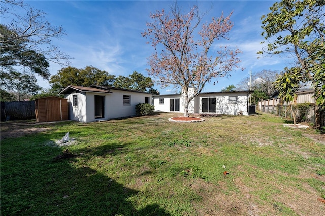 view of yard with a shed, fence, and an outdoor structure