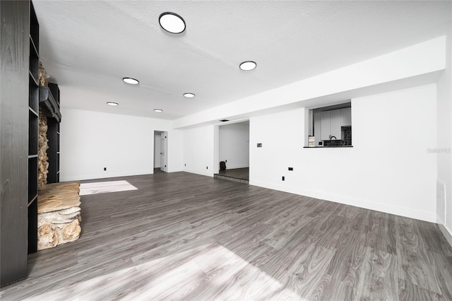 5438 San Luis Dr, Orlando, FL 32807 - unfurnished living room with baseboards, recessed lighting, and wood finished floors