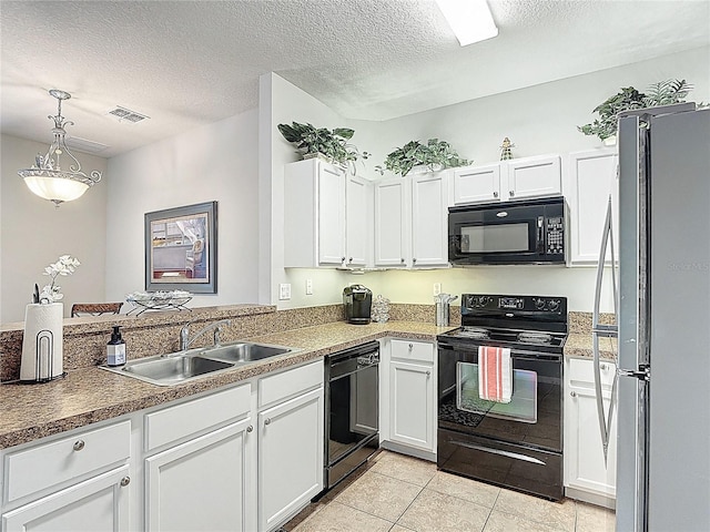 kitchen featuring white cabinetry, light tile patterned floors, a sink, visible vents, and black appliances