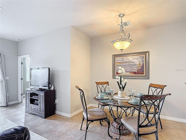 dining room featuring light tile patterned floors, baseboards, and visible vents