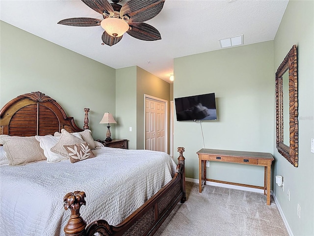 bedroom featuring light carpet, baseboards, a closet, and ceiling fan
