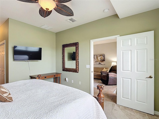 bedroom with ceiling fan, light colored carpet, and visible vents