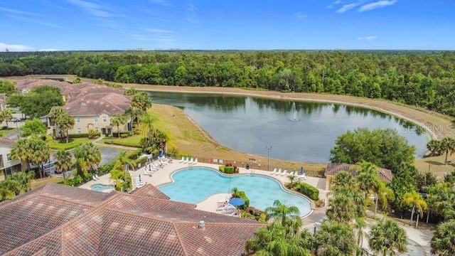 drone / aerial view featuring a water view and a forest view