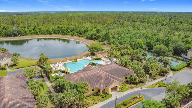 aerial view with a water view and a view of trees