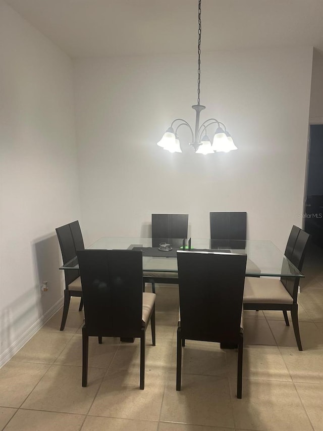 dining room featuring light tile patterned floors and a notable chandelier