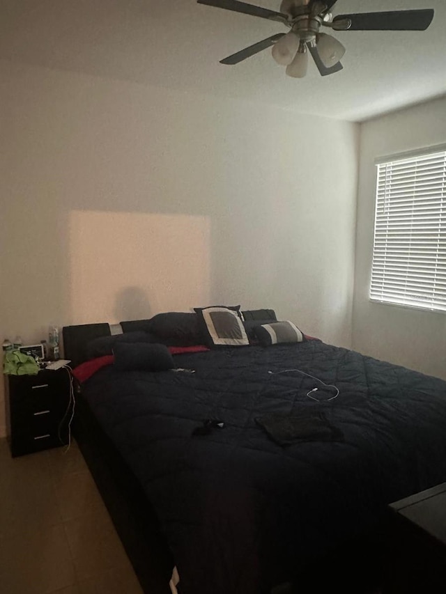 bedroom featuring tile patterned floors and ceiling fan