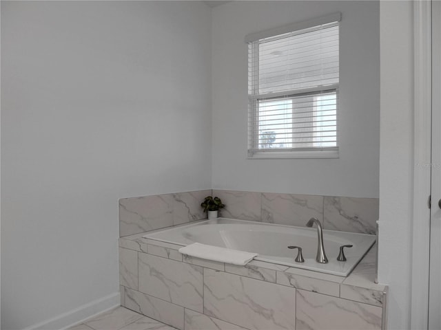 bathroom with a relaxing tiled tub