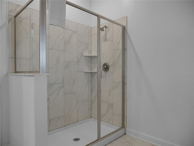 bathroom with a shower with door