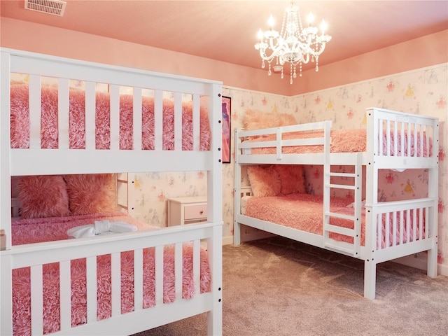 bedroom with carpet floors and a notable chandelier