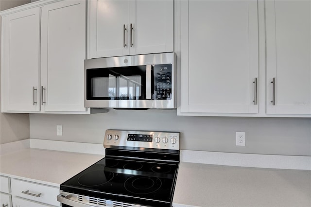 kitchen with white cabinetry and appliances with stainless steel finishes