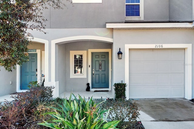 view of exterior entry with a garage