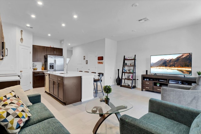 tiled living room featuring sink