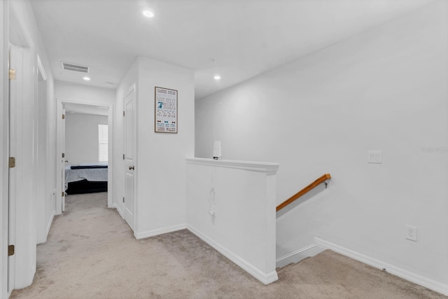 hallway with light colored carpet