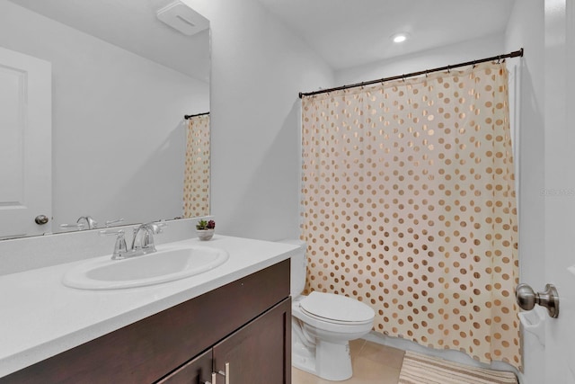 bathroom with vanity, tile patterned floors, and toilet