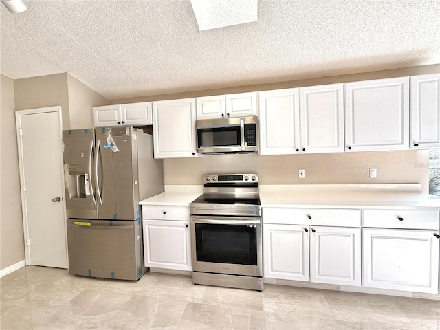 kitchen featuring white cabinetry, a textured ceiling, and appliances with stainless steel finishes