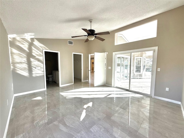 unfurnished bedroom featuring vaulted ceiling, a spacious closet, access to outside, ceiling fan, and a textured ceiling