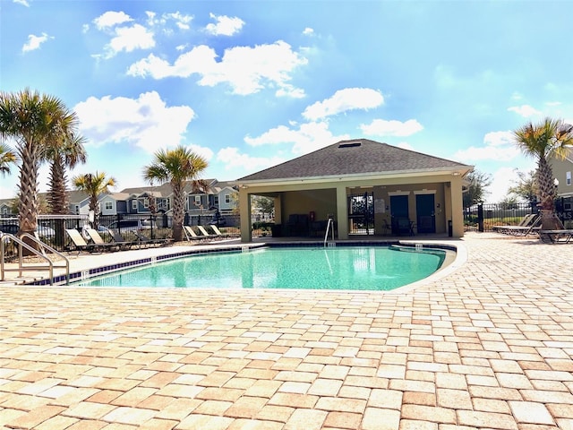 community pool featuring a patio area and fence