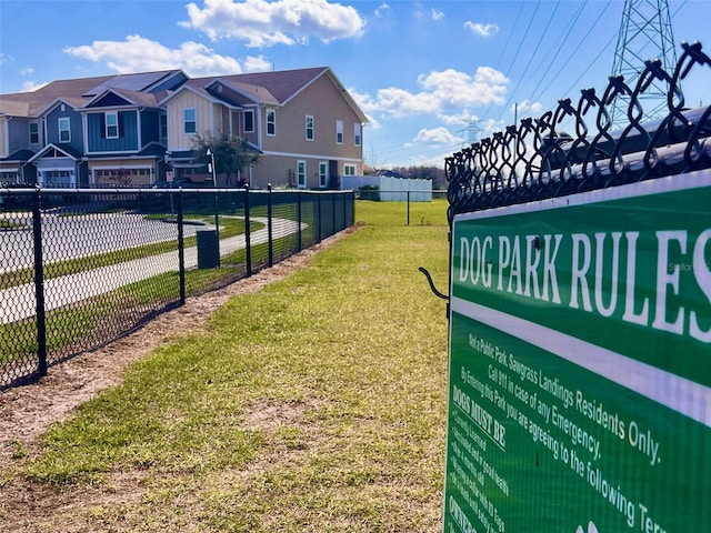 surrounding community featuring a residential view, fence, and a yard