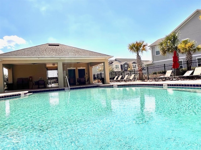 pool featuring a patio area and fence