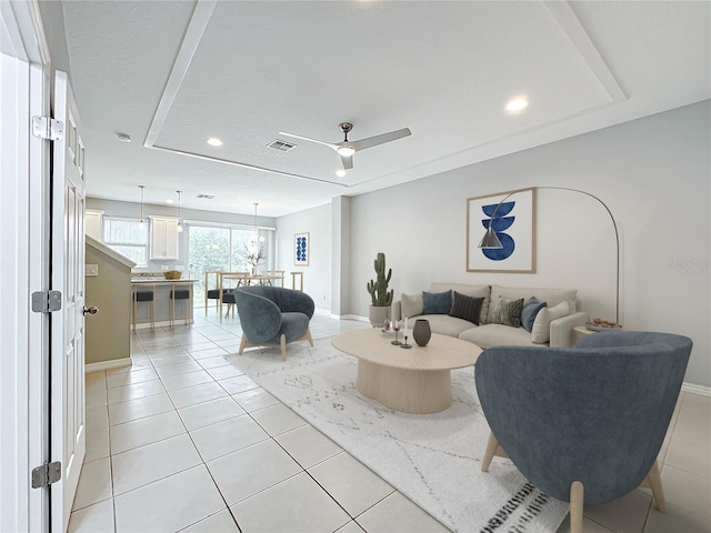 living area featuring light tile patterned floors, baseboards, visible vents, a ceiling fan, and recessed lighting