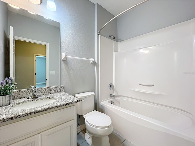 bathroom with toilet, vanity, and shower / bathtub combination