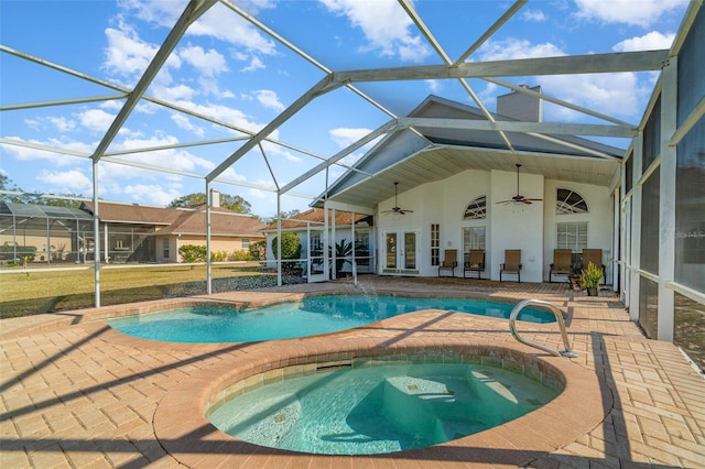 view of pool with french doors, a hot tub, a lanai, ceiling fan, and a patio