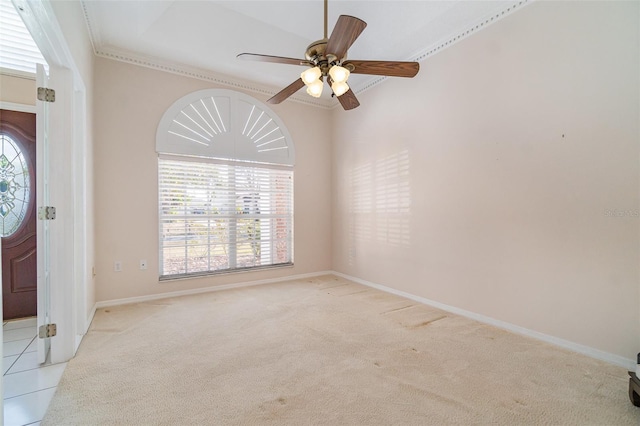 carpeted entryway with ornamental molding and ceiling fan