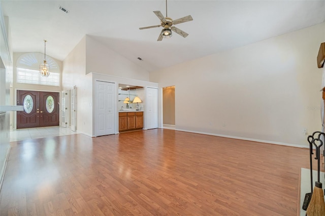 unfurnished living room with ceiling fan, high vaulted ceiling, and light hardwood / wood-style flooring