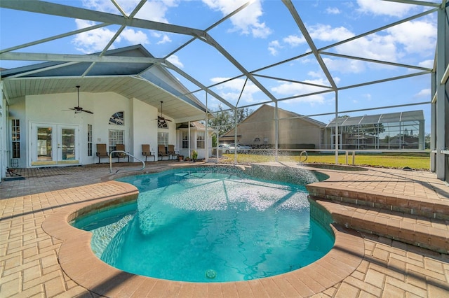 view of pool with a patio, a lanai, french doors, and ceiling fan