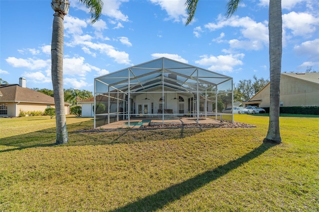 rear view of house featuring a patio, a lanai, a yard, and ceiling fan