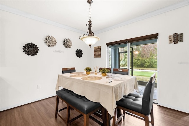 dining room with ornamental molding and dark wood-type flooring