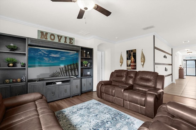 living room with dark wood-type flooring, ceiling fan, and ornamental molding