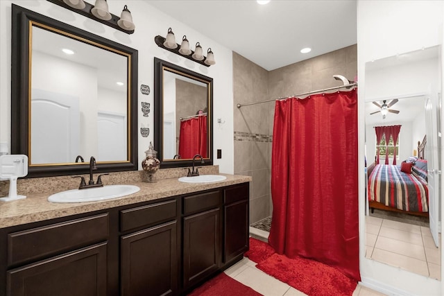 bathroom with tile patterned flooring, vanity, ceiling fan, and walk in shower