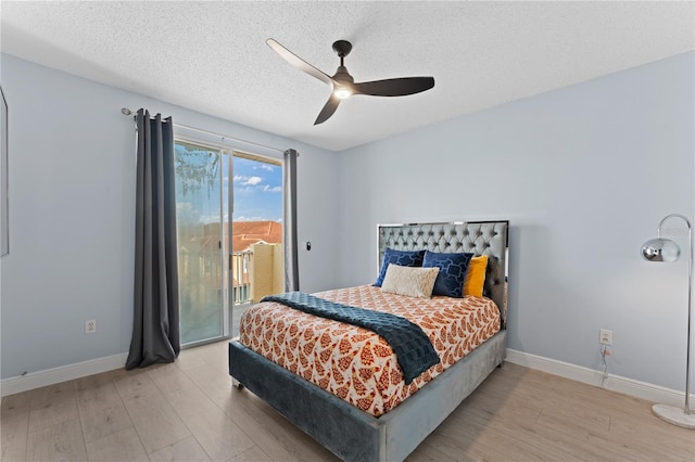 bedroom with ceiling fan, access to outside, a textured ceiling, and light wood-type flooring