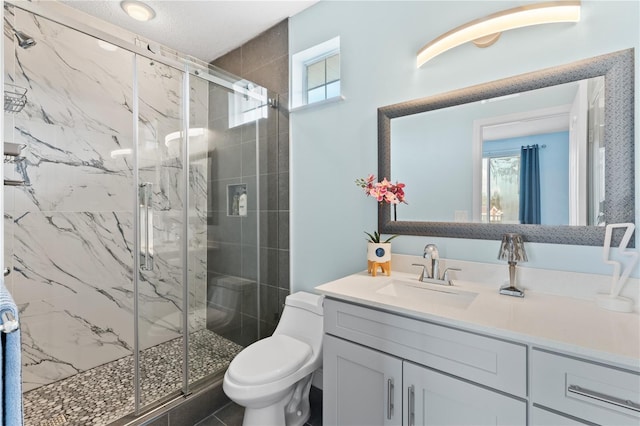 bathroom with vanity, toilet, and an enclosed shower