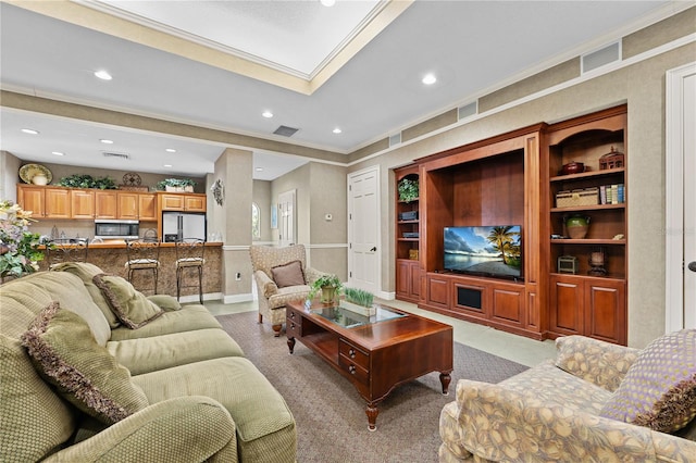 living room featuring ornamental molding and a skylight