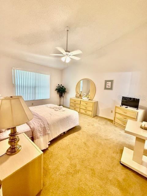 bedroom with ceiling fan, carpet, lofted ceiling, and a textured ceiling